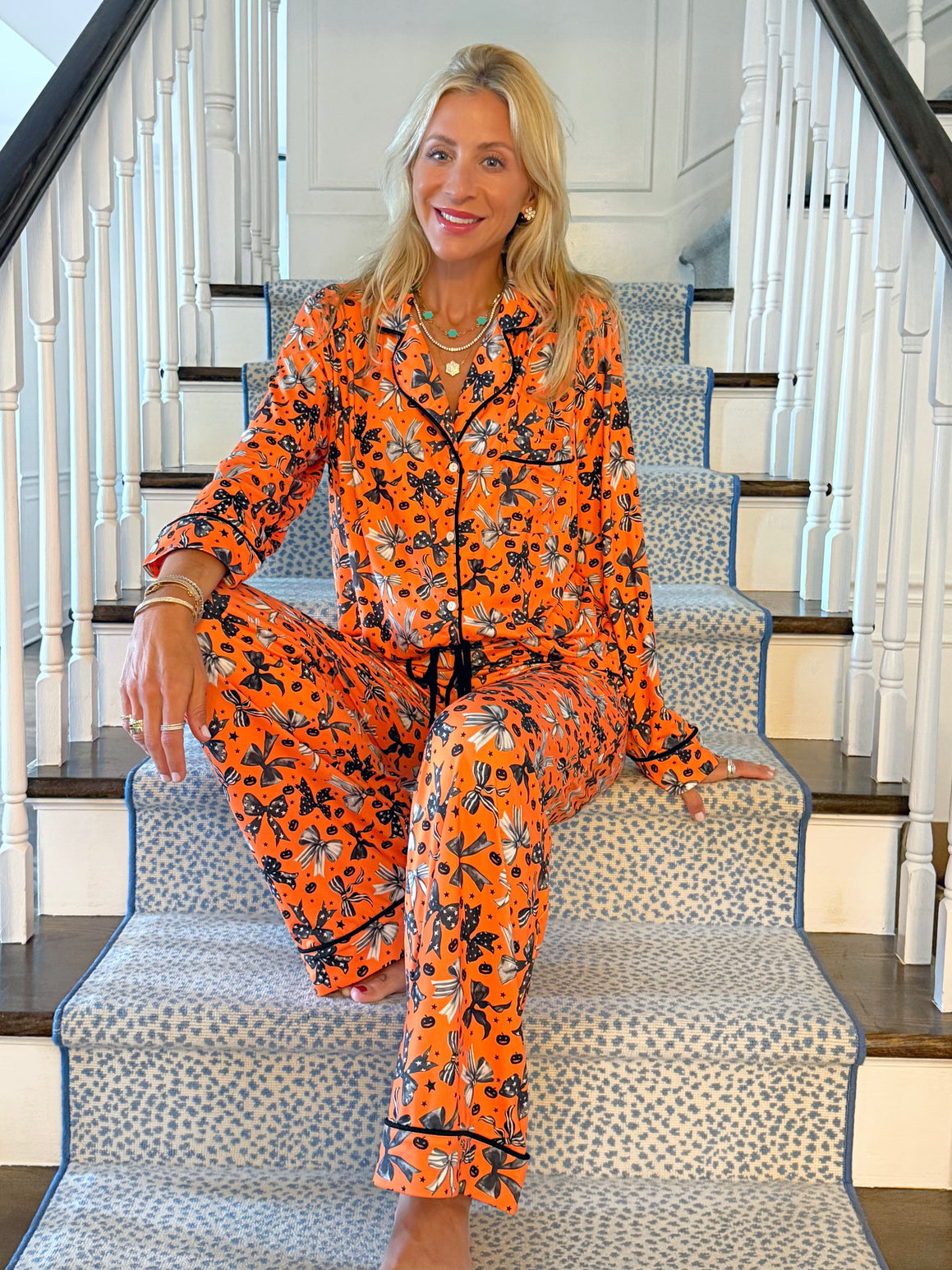 Woman in orange Halloween Bow pajamas by Sunshine Sisters