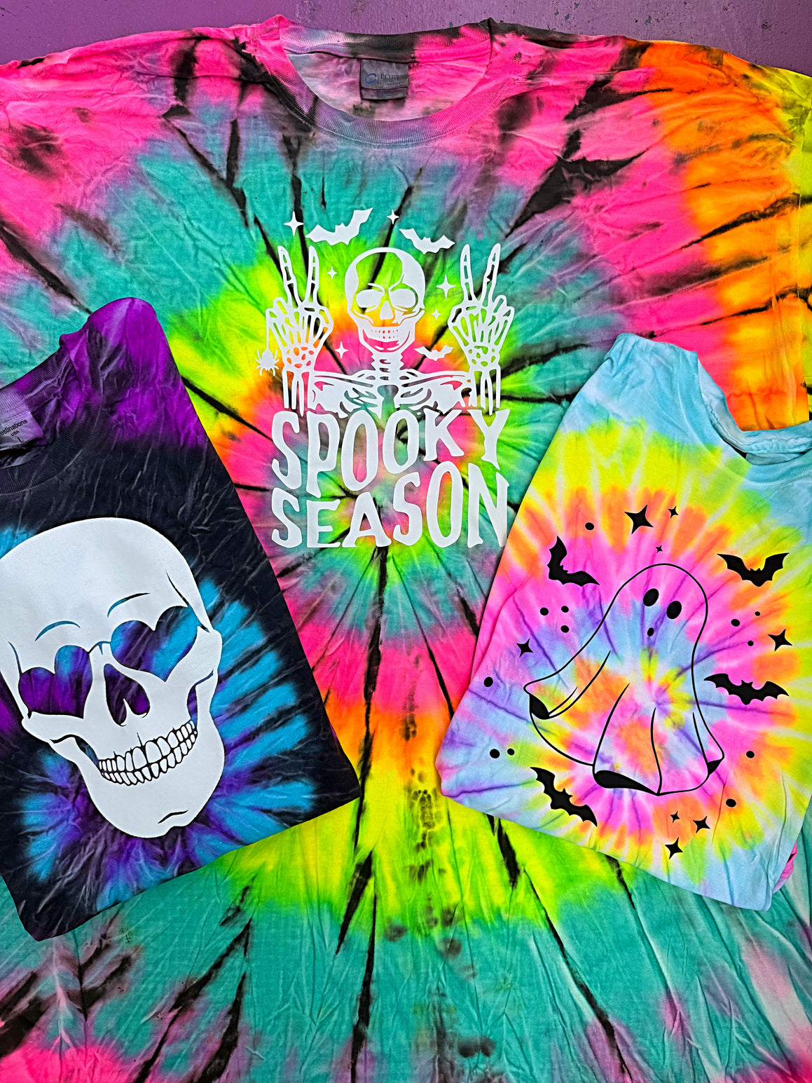 Colorful tie-dye t-shirt with Halloween-themed designs and 'Spooky Season' text.