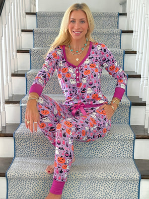 Jordann sitting on a staircase wearing the Hocus Pocus Ghost Jogger Pajama Set.