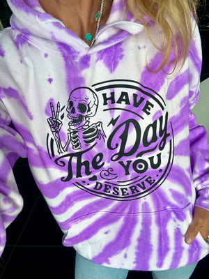 Purple and white tie-dye hoodie with skeleton graphic and text