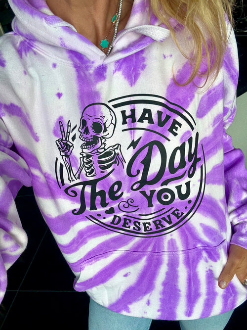 Purple and white tie-dye hoodie with skeleton graphic and text