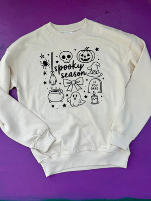 White sweatshirt with Halloween-themed graphics on a purple background